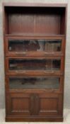 A vintage oak bookcase with glazed and bevelled lift up sections over panelled doors. H.211 W.106