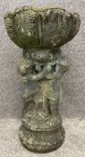 A finely cast composite stone bird feeder with cherub support. H.55cm