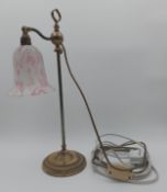 A vintage brass table lamp with rise and fall action and a glass shade. H.49cm