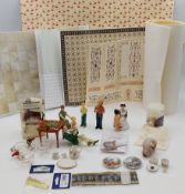 A collection of doll's house figures and other similar items.
