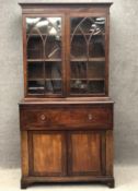 A 19th century mahogany two section library bookcase fitted with secretaire drawer. H.216 W.112 D.