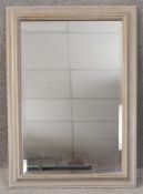 A contemporary mirror with a bevelled plate. H.90 W.64cm