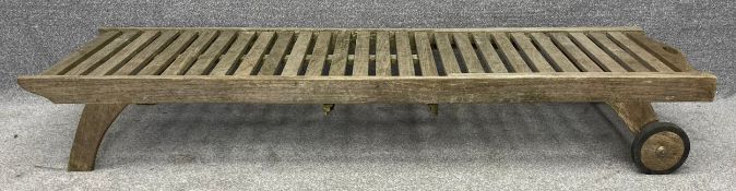 A Plantation Teak garden lounger with an adjustable back rest and maker's label. H.93 L.200 W.65cm