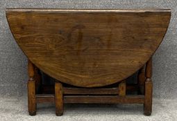 An 18th century country oak drop flap dining table with gateleg action. H.69 W.39 (129 extended) D.