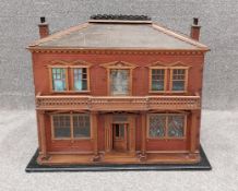 A vintage Victorian style double fronted doll's house with furniture and contents. H.56 W.68 D.39cm