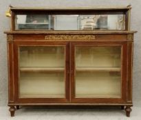 A Regency rosewood pier cabinet or chiffonier with ormolu mounts and brass inlay with a scrolling