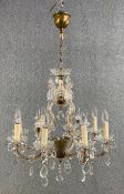 A metal framed and glass eight branch chandelier with cut crystal drops. Dia.63cm
