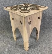 An Eastern carved hardwood stool with studded decoration. H.39cm