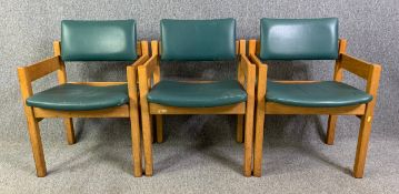 A set of three mid century light oak lounge armchairs in faux leather upholstery. H.80 W.57 D.