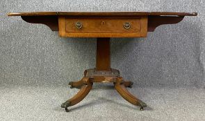 A Regency mahogany drop flap Pembroke table on pedestal base. H.74 W.61 (123 extended) D.97cm