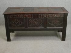 An 18th century carved oak coffer on stile supports. (In need of repair as seen). H.73 W.147 D.