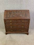 Bureau, 18th century country oak, well carved to the front and the fall with fitted interior. H.