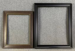 Two large contemporary picture frames; one heavy oak with gilt detail and one obeche with black