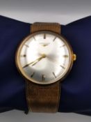A vintage Longines 9ct gold gentleman's automatic wristwatch with original strap. diameter 3.4cm 62g