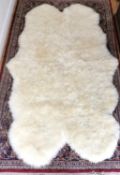 A large quad sheepskin rug. L.184 W.115cm