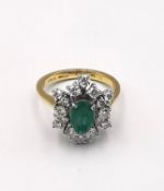 A vintage 18ct yellow and white gold emerald and diamond stylised floral cluster design. Set to