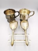 Two Empire silver babies brush sets and a pair of silver cups. Longest 15cm. 220g gross