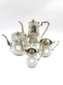 A silver plated and engraved four piece tea service comprising a teapot and a coffee pot with vine