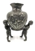 A French Art Nouveau Etaine Garanti pewter vase supported by two putti/cherubs with an indistinct