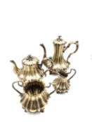 A Rococo style silver plated four piece tea service comprising a teapot, coffee pot, creamer and