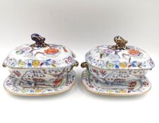 A pair of early 19th century Masons Ironstone covered tureens on stands, hand painted with the