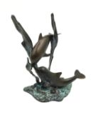 A cold painted and patinated figure of two dolphins playing on the seabed among seaweed. H.20cm
