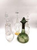 Five cut and etched glass decanters; one etched green Dutch decanter with a marked silver spout, one