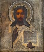 An 18th or 19th century Russian icon depicting Christ, in oil on gesso in an engraved silver oklad