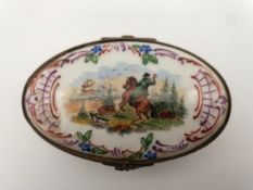 A late 18th or early 19th century German porcelain pill box hand painted to depict hunting scenes.
