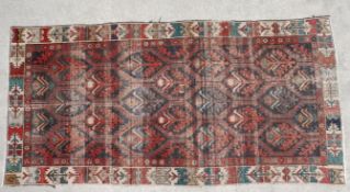A Belouch carpet with repeating stylised foliate motifs within multiple borders. L.272 W.134cm