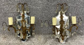 A pair of gilt brass, electric twin branch wall sconces with bevelled plate mirrors. H.34cm (each)