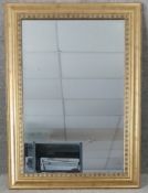 A contemporary gilt framed mirror with a bevelled plate. H.108 W.79cm