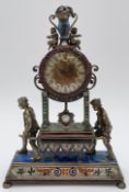 A Viennese style desk clock inset with semi-precious stones and with an engraved brass face. H.19cm