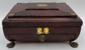 A leather bound ormolu mounted Regency sewing box with lion's head handles and lion's paw feet. H.16
