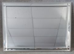 A contemporary mirror with bevelled glazed frame. H.73 W.104cm