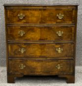 A 19th century Georgian style walnut and crossbanded serpentine fronted chest of drawers on shaped