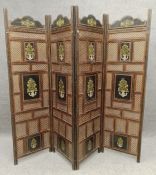An Eastern hand decorated pierced teak screen with gilt decoration and floral panels. H.117 W.