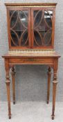 A 19th century satinwood bonheur du jour writing cabinet decorated allover with profuse scrolling