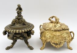 A finely cast 19th century brass inkwell with winged griffin feet and a faun playing a pipe, and a