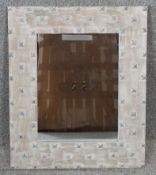 A contemporary limewashed oak mirror with stud work decoration. H.59 W.49cm