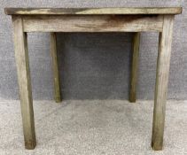 A weathered teak garden table. H.76 W.80 D.80cm