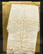 A framed and glazed 19th century silk and lace handkerchief with a note to the glazing dated 1860.