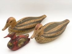 A pair of carved and hand-painted decoy ducks and a brass and painted waterbird. H.17 W.42cm (