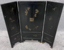 A small Chinese three panel screen with applied figural decoration. H.87 W.95cm (when open).