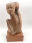 A carved figure on plinth base signed Davila. H.47 W.22