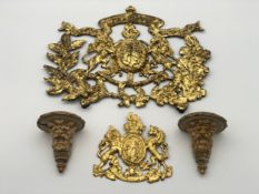 Two cast iron coats of arms along with two lion's head sconces, painted with gold leaf. H.29 W.W.