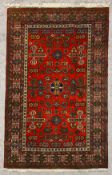 A contemporary handmade woollen Guba carpet with repeating stylised flowerhead motifs across a