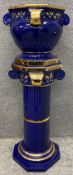 A contemporary blue and gold glazed jardiniere on stand in the classical style. (Crack to base as