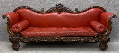 A mid 19th century rosewood scroll end sofa with carved foliate acanthus frame in burgundy leather