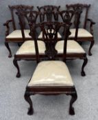 A set of six Georgian style mahogany dining chairs with carved splat backs on cabriole ball and claw